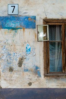 old window on facade of the old house