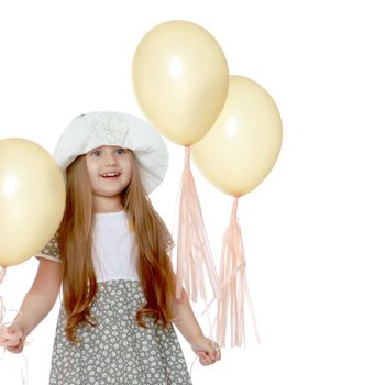 Little girl is playing with a balloon. The concept of a holiday, a birthday, a holiday in the fresh air. Isolated on white horse