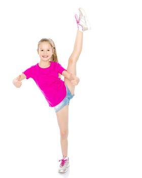 A sweet little girl shows gymnastic exercises that she learned at a sports school. The concept of sport and fitness. Isolated on white background.