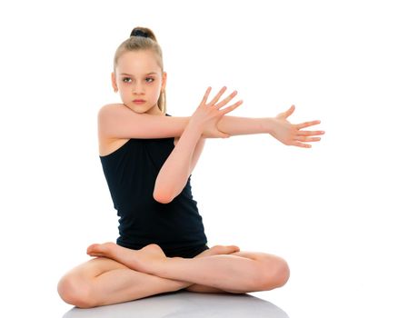 A nice little girl sits in a lotus position and meditates. Concept of yoga, happy people. Isolated on white background.