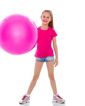 Beautiful little girl doing exercises on a big ball for fitness. The concept of sport and a healthy lifestyle. Isolated on white background.