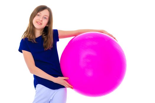 A charming little girl is engaged in fitness with a ball. The concept of gymnastics, health and sports. Isolated on white background.