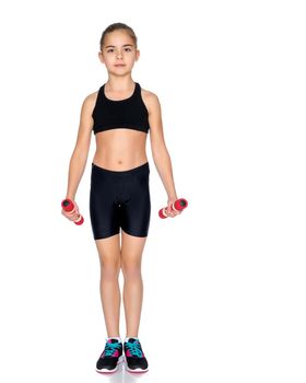 A cute little girl doing exercises with dumbbells. The concept of strength, health and sport. Isolated on white background.