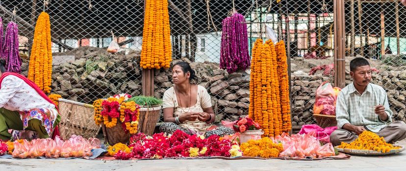 KATHMANDU, - OCTOBER 05: People sell flower necklaces near to Kathmandu Durbar Square in Kathmandu, Nepal, October 05, 2017