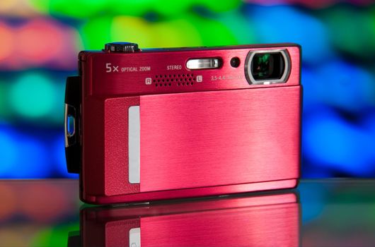 photo of the compact digital camera with beautiful background and glass reflection