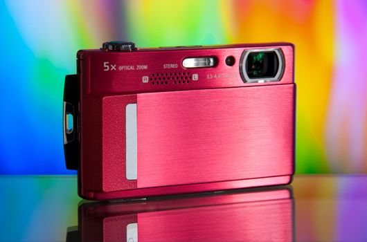 photo of the compact digital camera with beautiful background and glass reflection