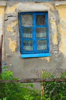 old window on facade of the old house