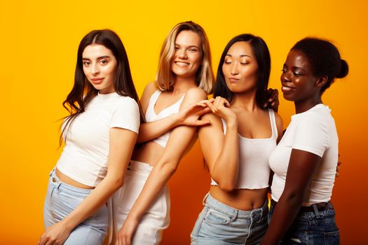 diverse multi nation girls group, teenage friends company cheerful having fun, happy smiling, cute posing on yellow background, lifestyle people concept, african-american, asian and caucasian close up