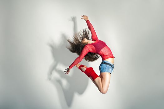 Modern style dancer posing on a studio white background