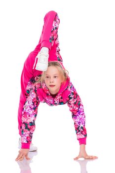 A girl gymnast performs an acrobatic element. The concept of childhood, sport, healthy lifestyle. Isolated on white background.