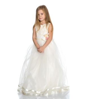 Charming little princess in a long dress. The concept of a happy childhood, beauty and fashion. Isolated on white background.
