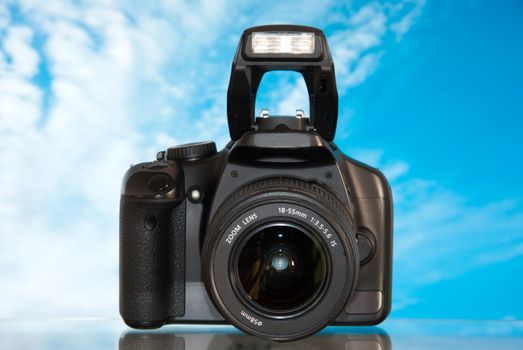 Dslr camera isolated on sky background with reflection