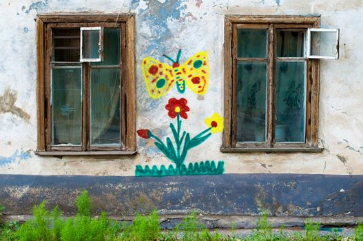 old window on facade of the old house