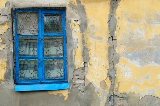 old window on facade of the old house