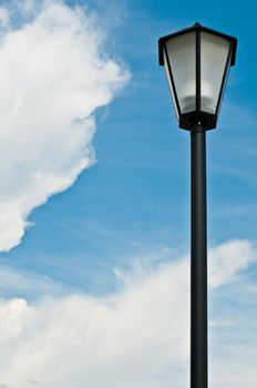 street lantern with blue cloudy sky in background