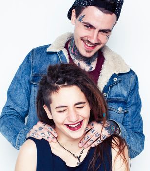 Young couple together. guy with tattoo, girlfriend wearing dreadlocks having fun on white background close up