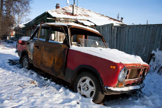 photo of old rusty car covered with snow