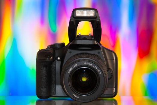 Dslr camera isolated on colorful background with reflection