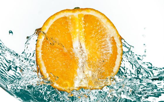 photo of water splash on half of orange