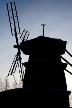 photo of the windmill silhouette with blue sky in background