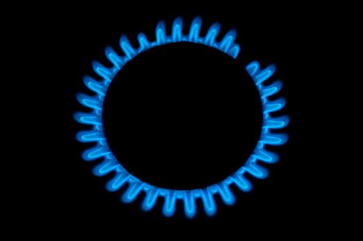 kitchen gas burning with blue flame isolated on black background