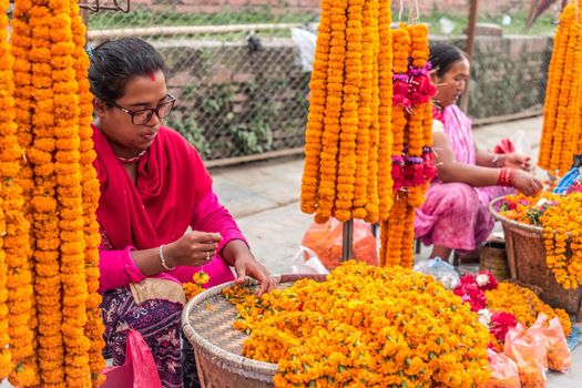 KATHMANDU, - OCTOBER 05: People sell flower necklaces near to Kathmandu Durbar Square in Kathmandu, Nepal, October 05, 2017