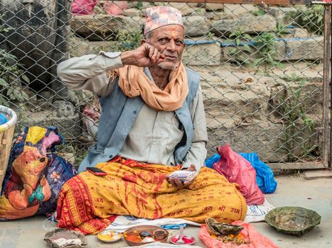 KATHMANDU, - OCTOBER 05: People sell flower necklaces near to Kathmandu Durbar Square in Kathmandu, Nepal, October 05, 2017