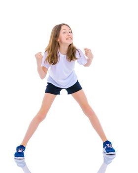 A little girl gymnast joyfully jumps and wags her hands. The concept of sport and fitness. Isolated over white background