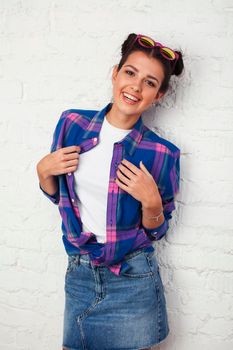 young pretty stylish hipster girl posing emotional isolated on white background happy smiling cool smile, lifestyle people concept close up