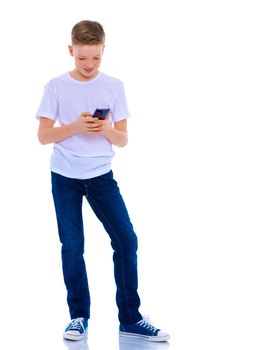 A small boy of school age uses a mobile phone. The concept of digital technology, communication between people. Isolated on white background.