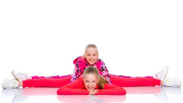 Girls gymnasts together make a twine. The concept of people, sport, fitness, healthy lifestyle. Isolated on white background.