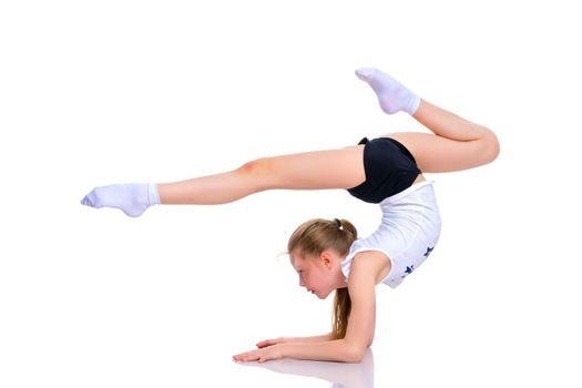 A girl gymnast performs an exercise stance on her forearms.The concept of childhood, sport, a healthy lifestyle. Isolated on white background.