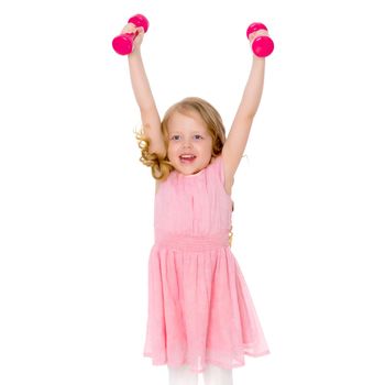 A cute little girl doing exercises with dumbbells. The concept of strength, health and sport. Isolated on white background.