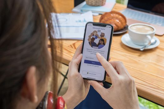 CHIANG MAI, THAILAND - JULY 28, 2021 : A working from home employee is downloading the Microsoft Teams social platform, ready for remote working in isolation from home