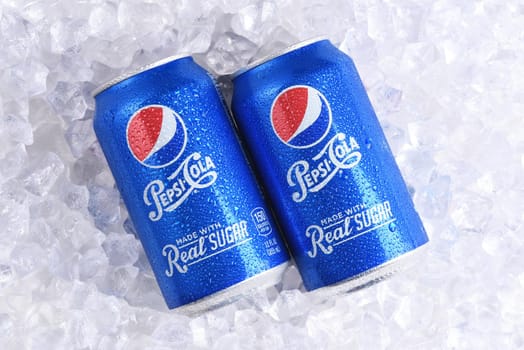 IRVINE, CALIFORNIA - MAY 23, 2018: Two cans of Pepsi-Cola Made with Real Sugar on ice. Formerly called Throwback, it is a brand of soft drink sold by PepsiCo.