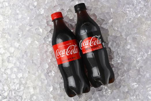 IRVINE, CALIFORNIA - 26 JUNE 2021: A bottle of Coca-Cola and Coca-Cola Zero in a bed of Ice.