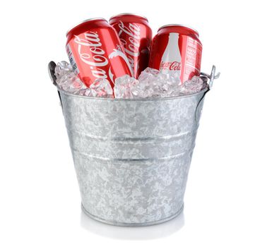 IRVINE, CA - January 09, 2014: Three Coca-Cola cans in an ice bucket. Coke is one of the most popular soft drinks in the world.