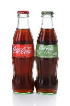 IRVINE, CA - FEBRUARY 15, 2015: Coca-Cola and Coca-Cola Life Bottles. Life is a reduced calorie soft drink sweetened with cane sugar and Stevia, containing 60% of the calories of Classic Coke.