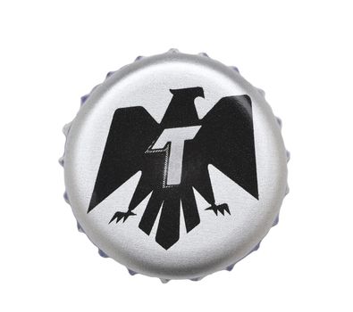 IRVINE, CALIFORNIA - 4 JUNE 2020: Closeup of a Tecate beer bottle cap on white.