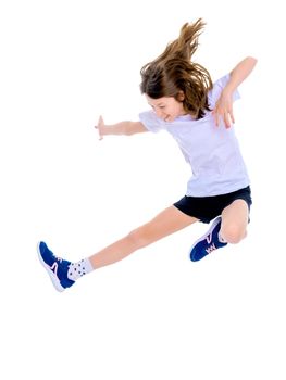 A little girl gymnast joyfully jumps and wags her hands. The concept of sport and fitness. Isolated over white background