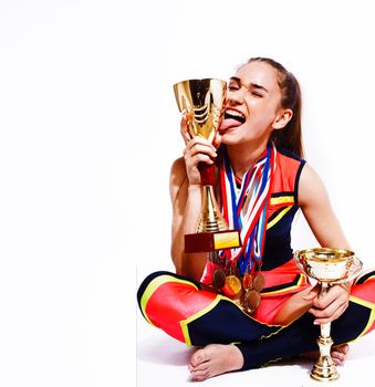 young smiling cheerleader girl with golden cups and price medals isolated on white background, lifestyle sport people concept close up