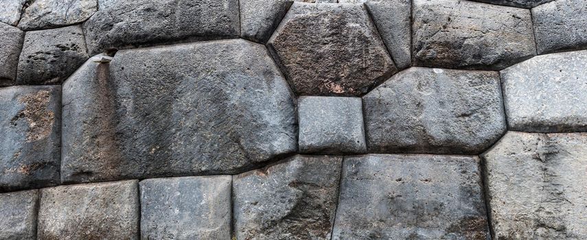 The stone wall made with poligonal masonry of fortification structures of ruined castle Saksaywaman
