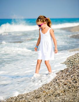 Adorable little girl on tropical beach vacation