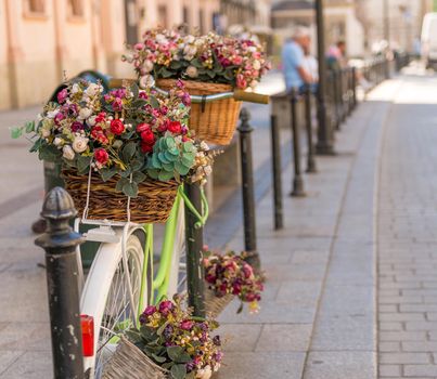 Bicycles decorated with flowers on the ancient cobbled street of Poland
