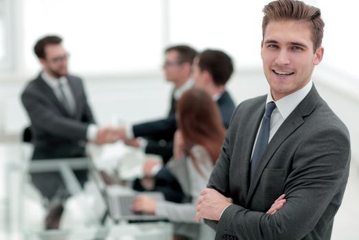 young businessman on blurred office background.