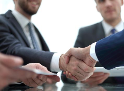 handshake business colleagues in office