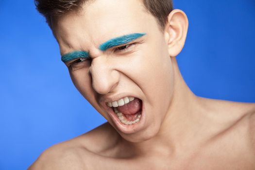 Beauty portrait of screaming handsome caucasian male with creative make-up