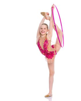 A girl gymnast balances on one leg.The concept of childhood, sport, a healthy lifestyle. Isolated on white background.