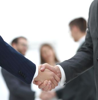 close-up of handshake business partners on blurred background
