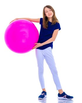 A charming little girl is engaged in fitness with a ball. The concept of gymnastics, health and sports. Isolated on white background.